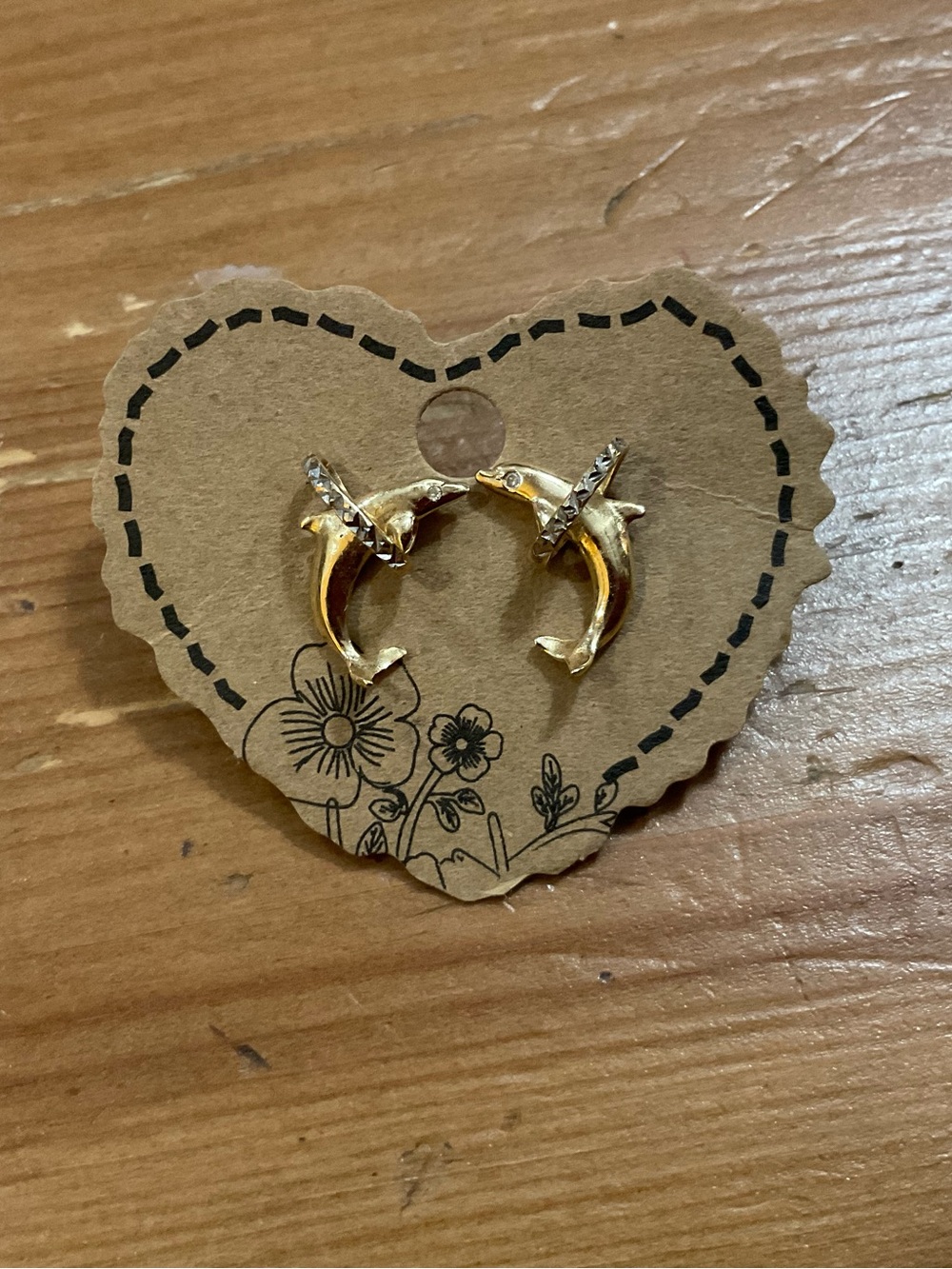 Vintage 14k. Gold stud pierced earrings featuring a jumping dolphin thou hoops.